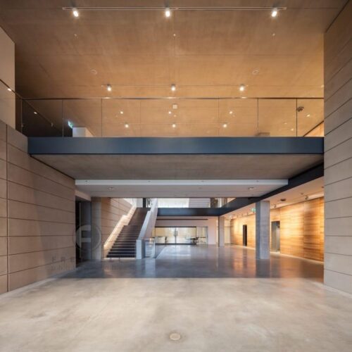 LED handrail system lighting up stairs at a museum.