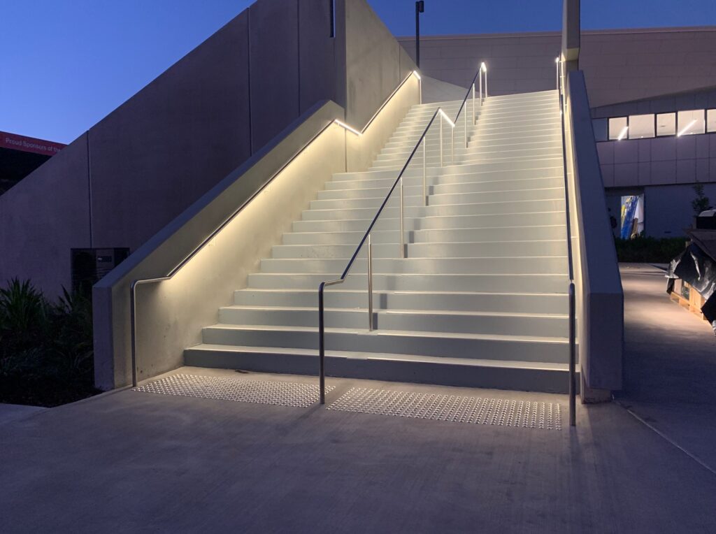 Evening view of the LED-lit stairs at Ballymore Rugby Stadium.